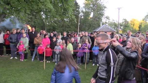 Active children play sack race in city park with people audience — Stock Video