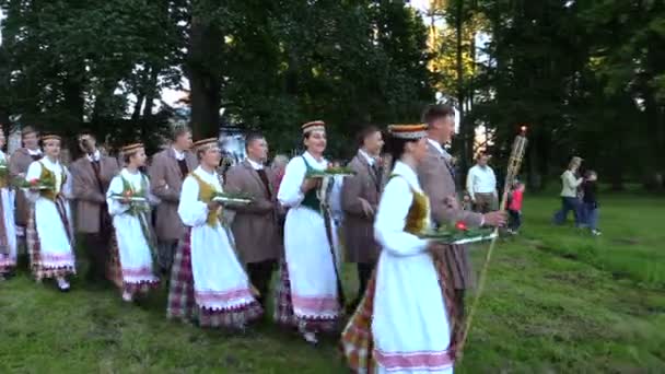 Människor par i nationella kläder föra brinnande fackla och ljus — Stockvideo