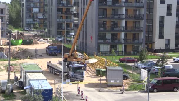 Werknemers uit het geheugen verwijderen betonnen blok met kraan in bouwplaats — Stockvideo