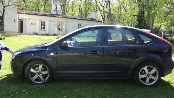 Panorama de jovem limpar lavar preto carro favorito com espuma — Vídeo de Stock