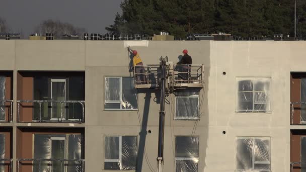 Maler streichen Wohnhauswand mit Sprayer weiß an. 4k — Stockvideo