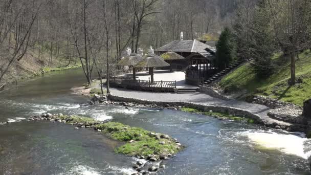 River water fall near empty resort with straw arbor. 4K — Stock Video