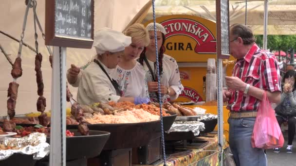 Donna venditore vendere torta al forno per l'uomo nel mercato cittadino in strada. 4K — Video Stock