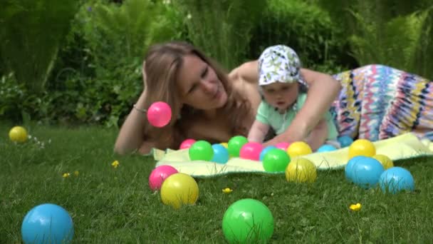 Mãe e bebê tempo livre no parque com bola colorida. 4K — Vídeo de Stock