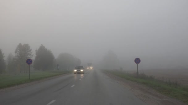 Unidad de coche en la niebla carretera del campo. 4K — Vídeos de Stock