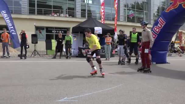 Командные соревнования роликовых конькобежцев в эстафете с барьерами. 4K — стоковое видео