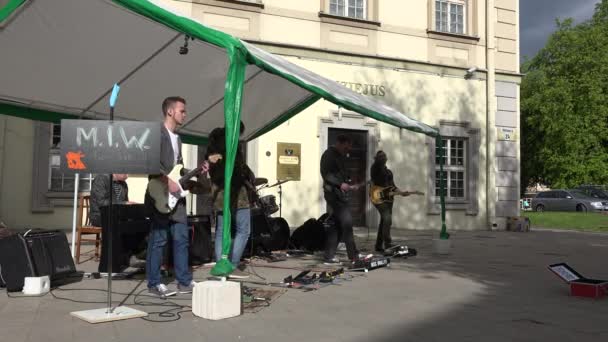 Chicos juegan con la guitarra eléctrica y baterista en la calle arbors techo. 4K — Vídeo de stock