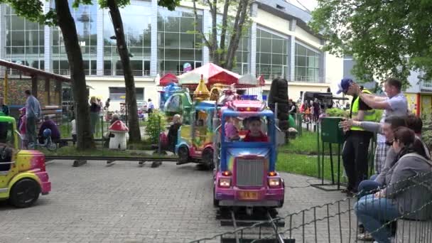 Pais cuidar de crianças crianças em carrossel carros de trem. 4K — Vídeo de Stock