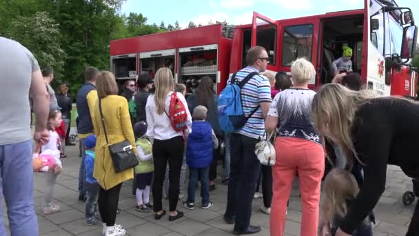 Parent with children around military emergency fireman truck. 4K — Stock Video