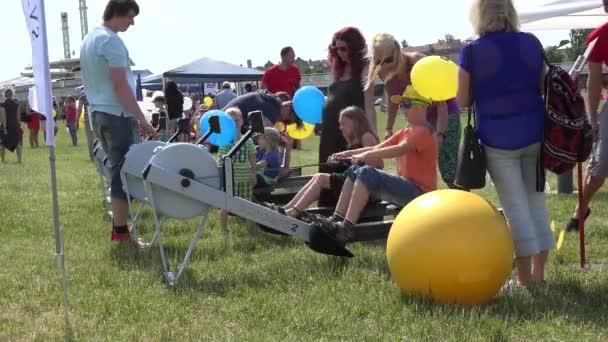 Parents with children exercise on outdoor club fitness equipment. 4K — Stock Video