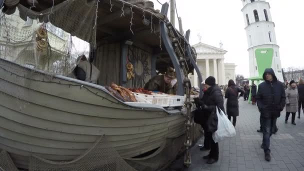 People buy fish from fisherman woman in ship imitation market — Stock Video