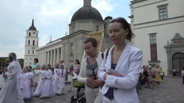 People walk in christian religious procession main city street. 4K — Stock Video