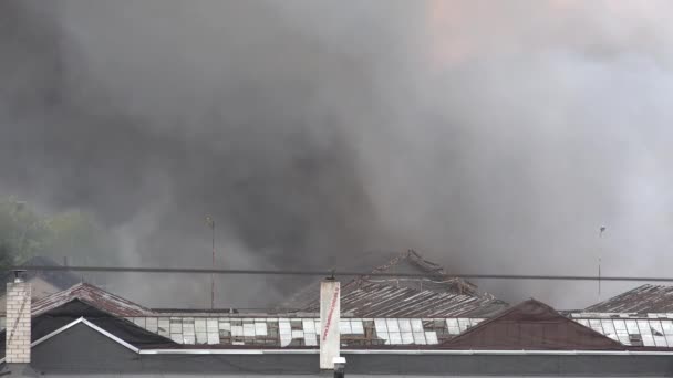 Brinnande lagerbyggnader med svart rök stiger från tak. 4K — Stockvideo
