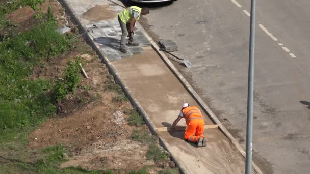 Construction worker prepare ground base foundation for tile pave lay. 4K — Stock Video