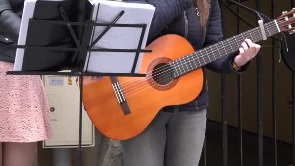 Girls group play guitar and sing. Note paper sheet. 4K — Stock Video