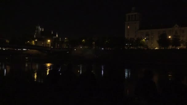 People enjoy modern laser projections effects on river at night. 4K — Stock Video