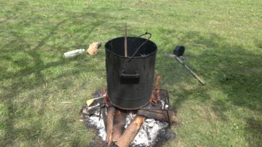 reçine dışında ateş çayır üzerinde kirli bir potu kaynar. 4k