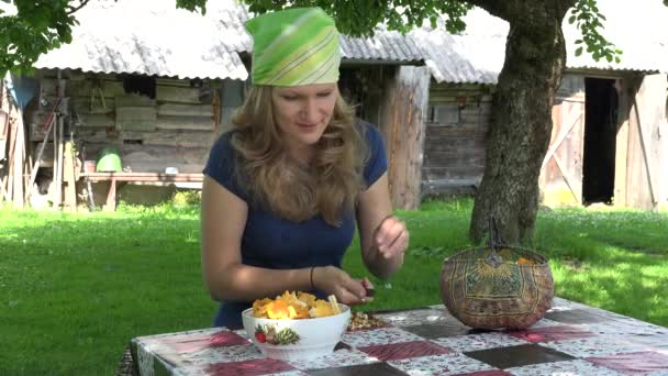 Mujer aldeana con cuchillo limpio champiñones cantarela en la mesa. 4K — Vídeos de Stock