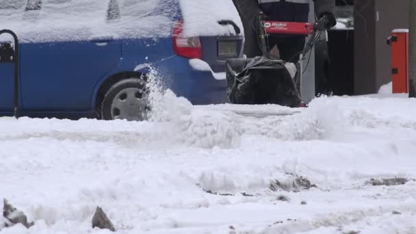 Modernas casas planas quintal e homem usando ventilador de neve no quintal de inverno. 4K — Vídeo de Stock