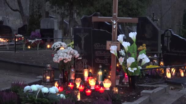 Pietre tombali del cimitero rurale e candele colorate bruciano di sera. 4K — Video Stock