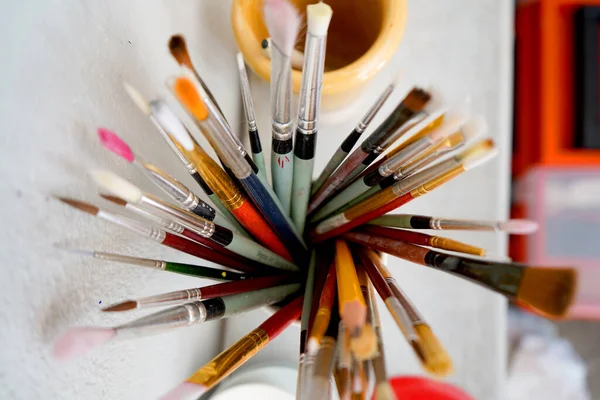 Detail of paint and brushes in an artist\'s studio