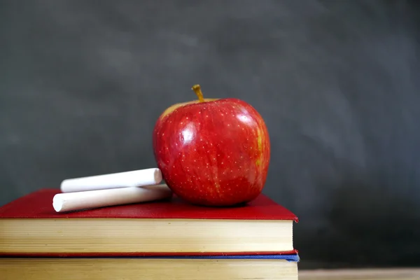 Red apple on books in classroom Stock Photo