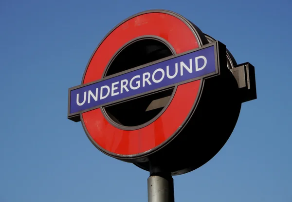 Red and blue underground sign in london — Stok fotoğraf