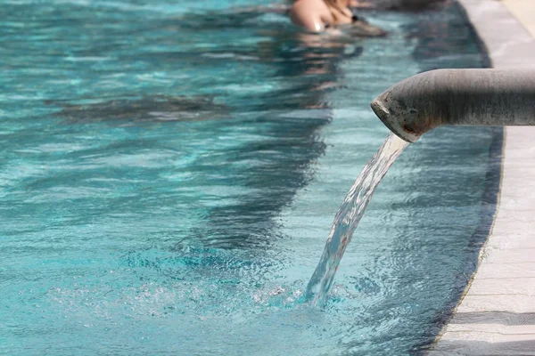 Hot water flowing into a pool, spa background — Stock Photo, Image