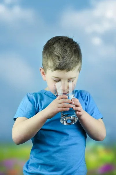 Portrait of boy drinking glass of water — Stock Photo, Image