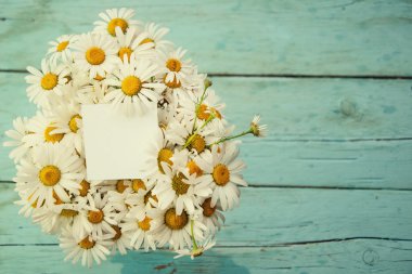 Tasarım öğesi. Eski tahta üzerinde papatya buketi.