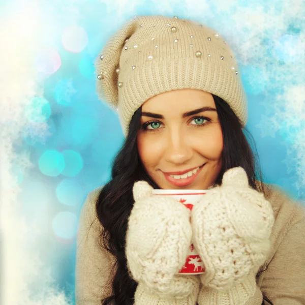 Young woman with cup on winter holiday background. — Stock Photo, Image