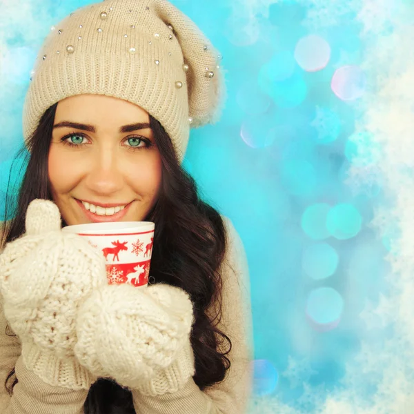 Young woman with cup on winter holiday background. — Stock Photo, Image