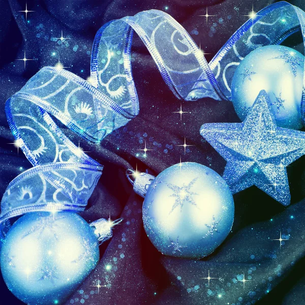 Christmas decorations and ribbon on a blue background — Stock Photo, Image