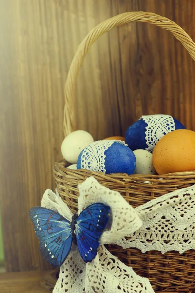 Huevos de Pascua en la cesta de tablas de madera . — Foto de Stock