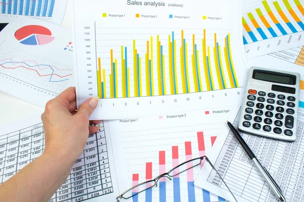 Financial printed paper charts, graphs and diagrams on the table