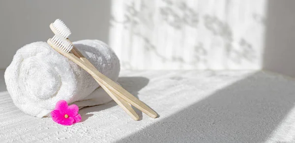 Bamboo brushes and towels . Light and shadows. Spa treatments. Concern for the environment . Bath treatments. Article about the spa . Copy space