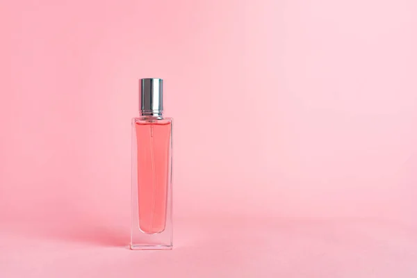 Perfume bottles on a pink background . Aromatherapy. The scent of perfume. The choice of fragrance. Pink background. Copy space