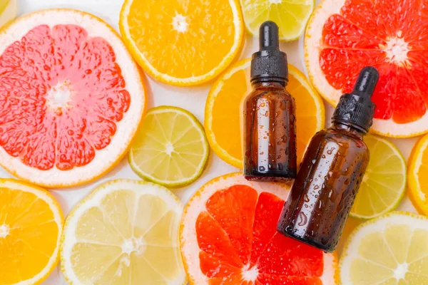 Cosmetic oil and citrus fruits . The concept of a bottle of cosmetic oil without a name. Cosmetology. Skin care. Spa Stock Photo