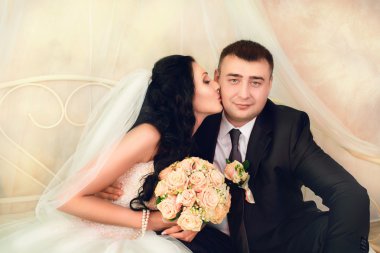 Gelin ve damat stüdyoda poz veriyor.