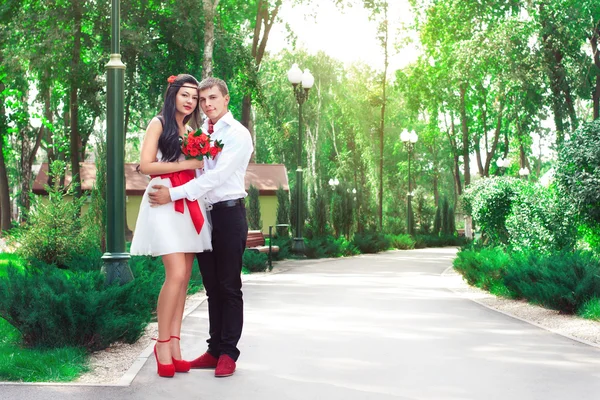 Bride and groom posing in amusement park — Stock Photo, Image