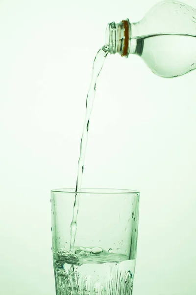 Man Pours Water Transparent Plastic Bottle Glass — Stock Photo, Image