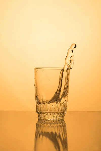 Alcoholic drink or water in a glass, splash, splash