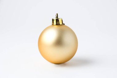 Noel süslemeleri beyaz arka planda parlak altın top.