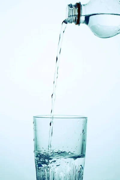 Man Pours Water Transparent Plastic Bottle Glass — Stock Photo, Image
