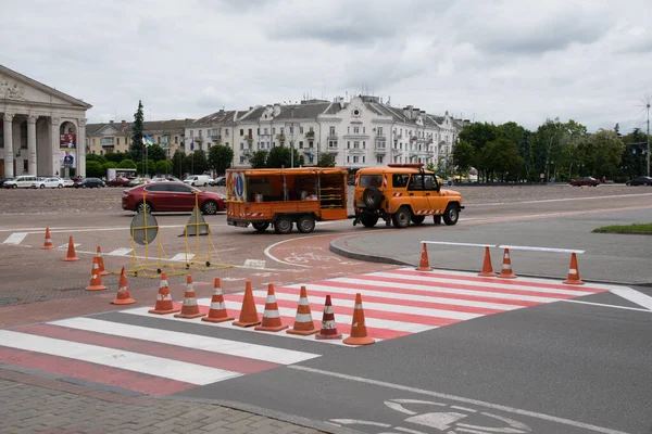 Украина, Чернигов, 11 июня 2021 года: Ремонт дорог в городе, рабочие наносят дорожную разметку в центре города. — стоковое фото