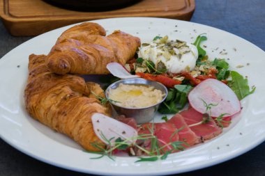 Etli kruvasan, yumurta ve sos, restoran atıştırmalığı.