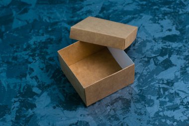 Gri arka planda boş hediye kare el işi kutusu, kopyalama alanı. Hediye fikirleri kavramı eksikliği.