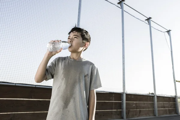 Boy drinks water on a hot day. — Stock Photo, Image