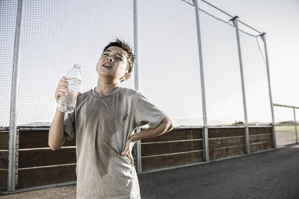 Boy shows exhaustion after practice. — Stock Photo, Image