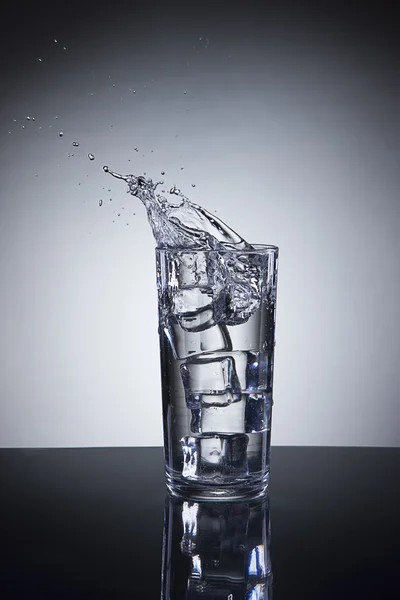 Small splash in water glass. — Stock Photo, Image